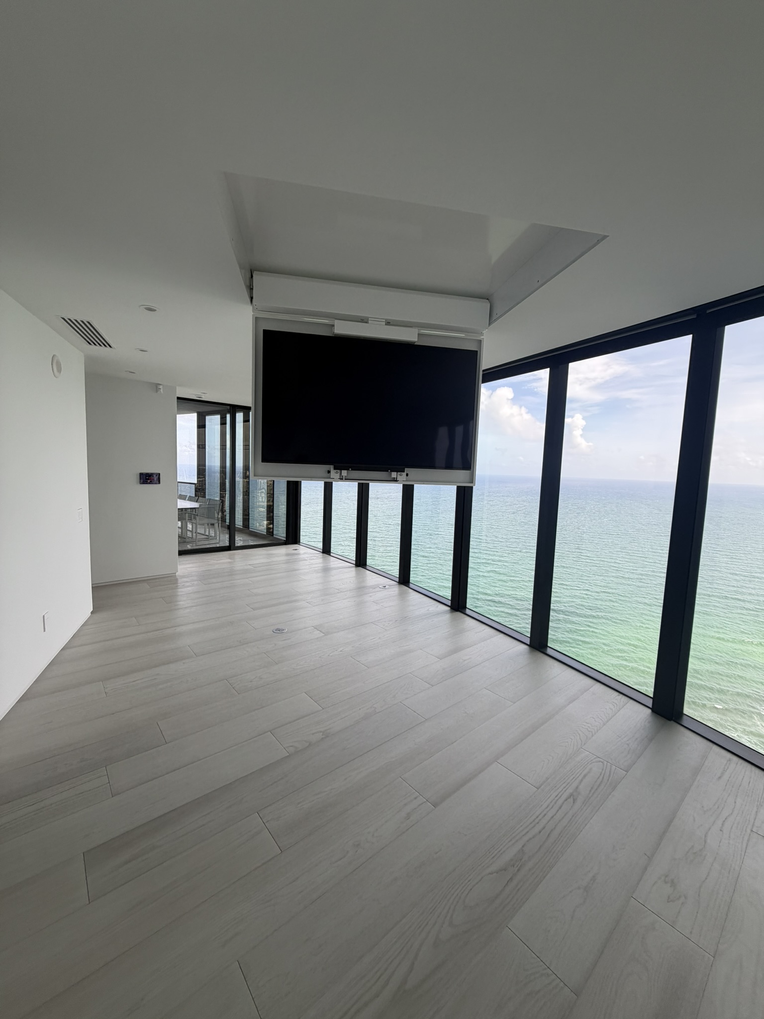 Ceiling mounted television with an ocean view